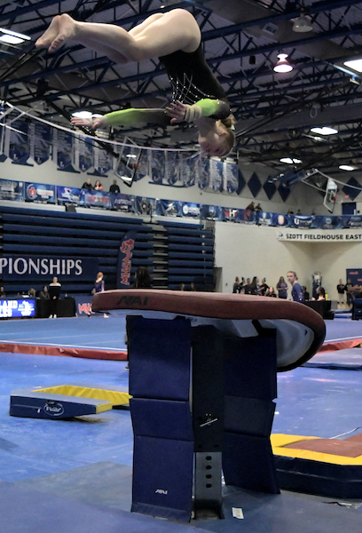 ydia Beaton competes on vault for the Comets, on the way to finishing first.