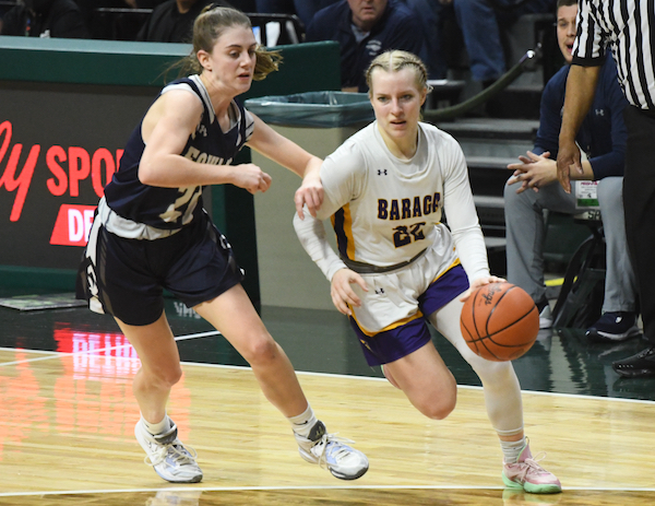 Baraga’s Corina Jahfetson (22) works to get past Fowler’s Grace O’Hare.