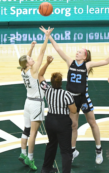 The Cougars’ Leah Richards (22) and West Catholic’s Reese Polega (32) contend for the opening tip-off.