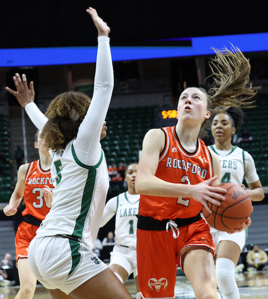 The Rams’ Anna Wypych (2) drives to the basket with West Bloomfield’s Sydney Hendrix (5) defending.