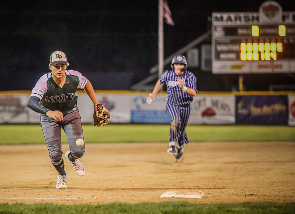 Reeths-Puffer third baseman Trent Reichert goes for the ball as a Fruitport baserunner closes in during Fruitport's seventh-inning rally in the 10-5 victory. 
