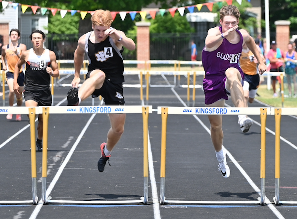 Iron Mountain's Will Fairchild, left, and Gladstone's Luke Bracket are step for step with each other in the 300 hurdles.