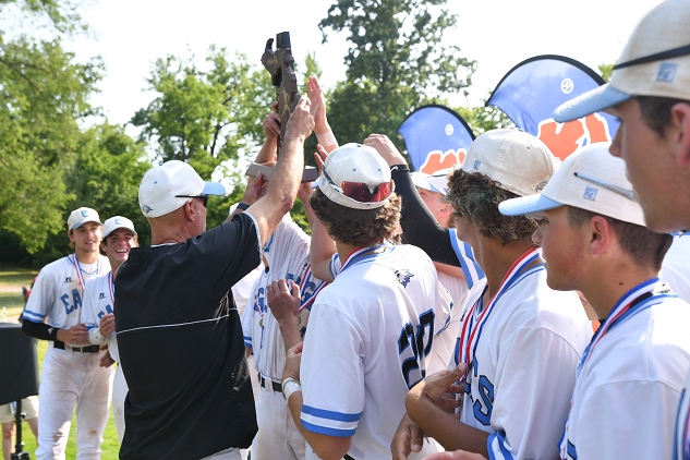 Gates presents the championship trophy this season to his Grand Rapids Christian players.