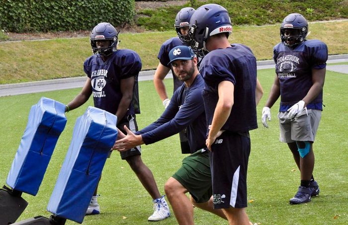 Jones works with his linemen during his first year as head coach at Bloomfield Hills Cranbrook Kingswood in 2019. 