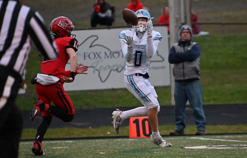 Petoskey's Seth Marek (0) catches a pass from quarterback Joseph McCarthy that he takes into the end zone.