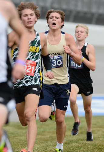 Traverse City St. Francis’ Leo Swager (1130) pushes with a pack as the top finisher for the team title winner. 