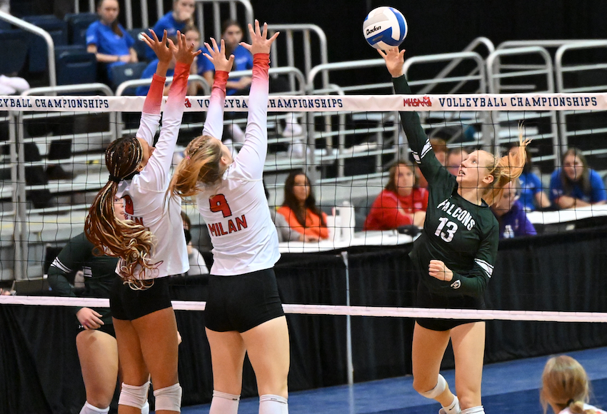 Grand Rapids West Catholic Ella Bernreuter (13) connects on a kill attempt during a 25-16, 25-13, 25-19 win in Division 2, with Milan’s Lauryn Parris (4) and Malea Wourman (8) blocking. Bernreuter finished with six kills for the Falcons (38-9-6).