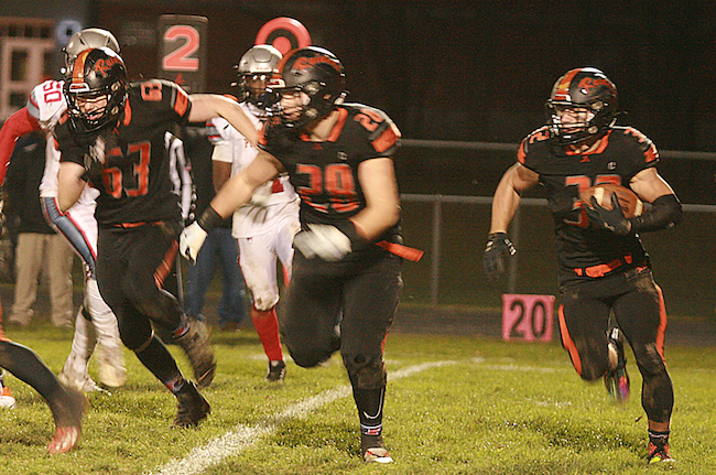 Chase Battani (32) followers his Raiders blockers during the Regional Final win over Detroit Edison. 