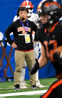 Stags assistant coach Conner Schueller watches from the sideline during an Almont run back.
