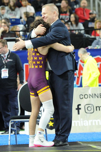 Coach Steve Vlcek embraces Stewart after the victory.