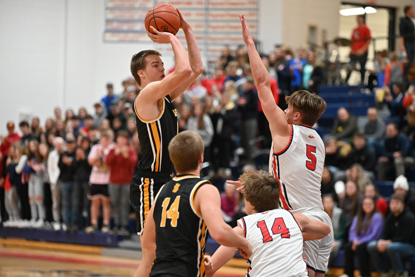 Iron Mountain's Oskar Kangas goes up for a shot while being defended by Ishpeming Westwood's Edward Anderson during the Mountaineers’ 67-43 win Friday. 