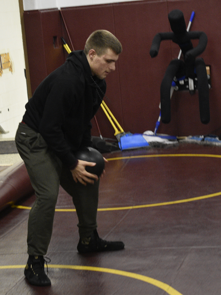 Niles Brandywine senior Gavin Schoff works out with the heavy ball at a recent Bobcats' wrestling practice. 