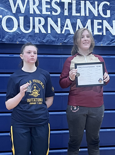 Niles Brandywine junior Maddison Ward, right, stands on the podium after winning the championship in the 170-pound weight class at the Adam H. Provencal Invitational this season at Grand Haven High School.