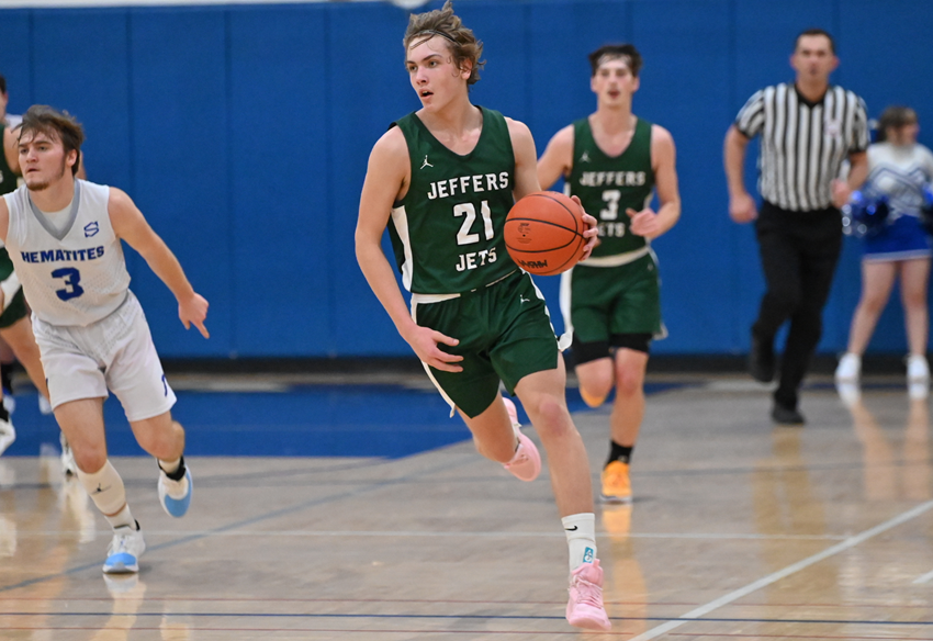 Painesdale-Jeffers' Matthew Shutz (21) brings the ball up the court during his team’s game with Ishpeming this season. 