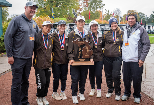 Fodale, third from left, celebrates her team’s Division 1 golf championship in the fall. 