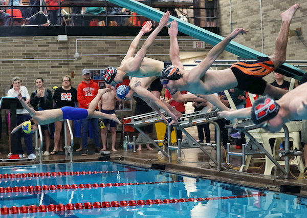 Swimmers launch at the start of the 50 championship race. 