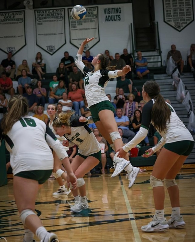 Harmony Laker (12) soars to get a hand on a ball during volleyball season. 
