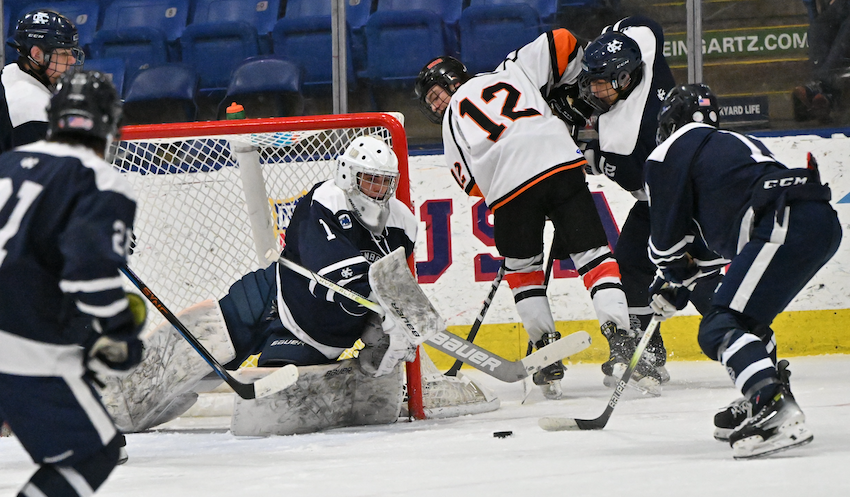 Bloomfield Hills Cranbrook goalie Garrett Dudlar covers the left side of the goal with a loose puck in front of the crease. Dudlar had 35 saves in the Cranes 5-0 Semifinal win over Houghton.