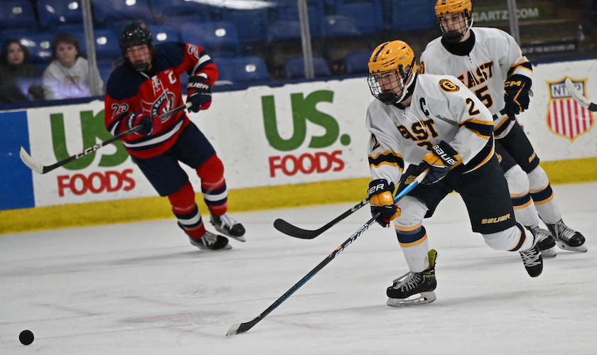 East Grand Rapids senior Ian MacKeigan charges toward the puck during his team’s 3-0 win over Traverse Bay Reps as the Pioneers earned their second-straight championship game berth.