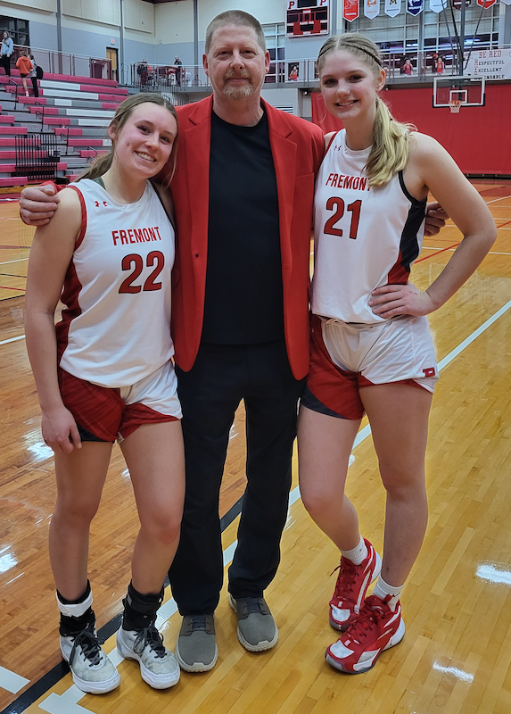 Packers captains Katie Ackerman (22) and Jessica Bennett with coach Peter Zerfas.