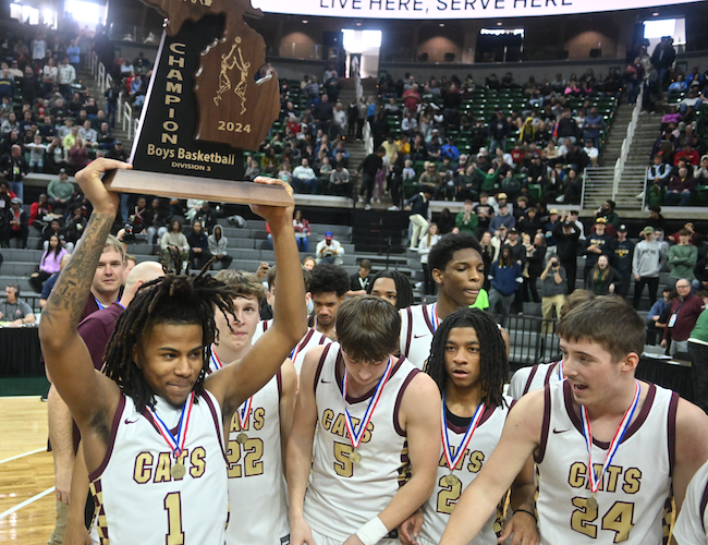 Jamier Palmer (1) raises the trophy surrounded by teammates. 