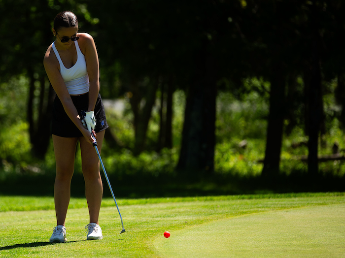 West Iron County's Kya Dallavalle putts on No. 17.