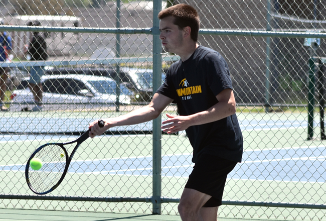 Iron Mountain senior Reece Kangas lines up a forehand shot during the No. 1 doubles championship decider.