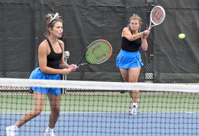 Forest Hills Northern’s Paige McKenzie, right, with partner Ryan Morey, sends back a powerful volley at No. 1 doubles.