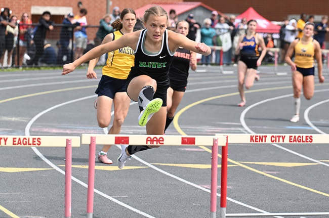 Olivet's Emily Peters clears a hurdle on her way to a third championship in the 300.