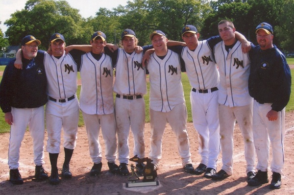 The Kents anchor a photo with North Muskegon players and their District championship trophy in 2009.