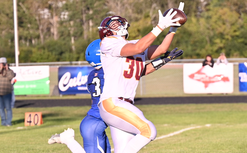 On Ontonagon's first possession of the game, Jack Nelson (30) catches a pass from Brody Bobula (not shown), while being defended by Ishpeming's Grady Gauthier (3), and runs it in for a touchdown.