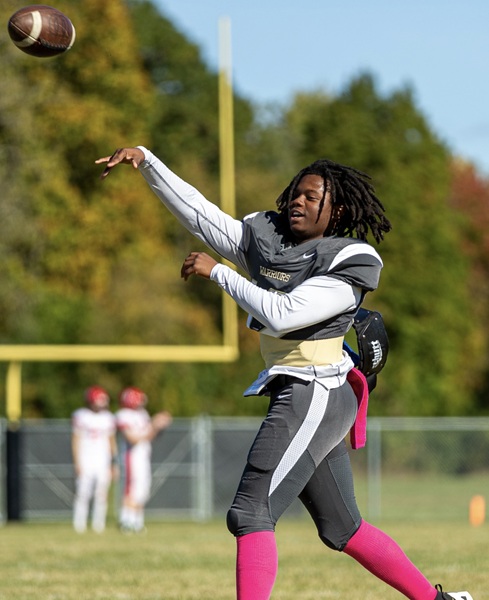 Warriors quarterback Deion Wright throws a pass during warmups. 