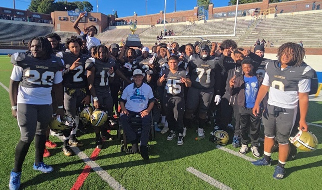 Flint Elite takes a photo together after winning its Vehicle City Gridiron Classic matchup with Erie Mason.