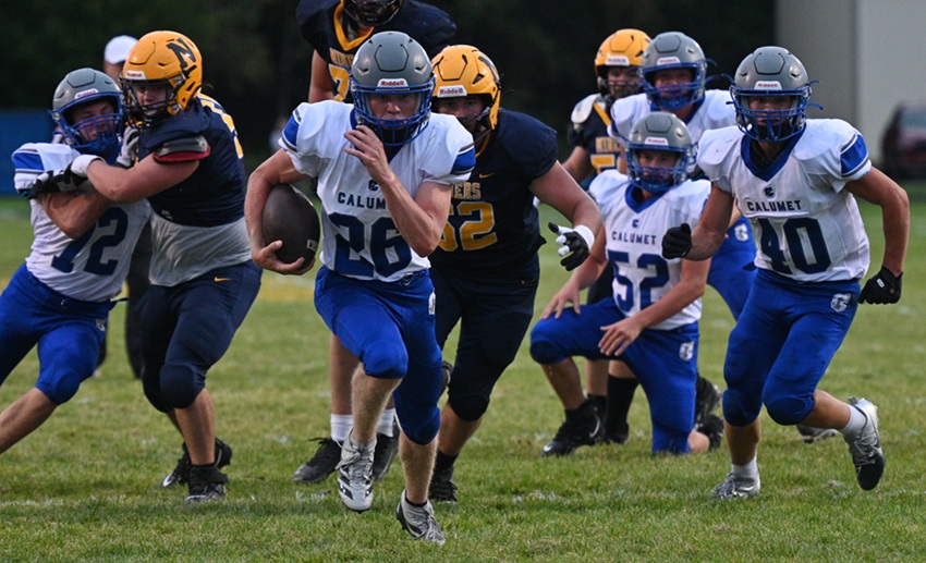 Calumet's Ben Anderson finds a hole and gains several yards against Negaunee.
