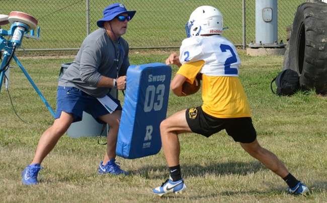 Jefferson coach Rob Beaudrie holds a pad while Luke works on making a cut during practice.