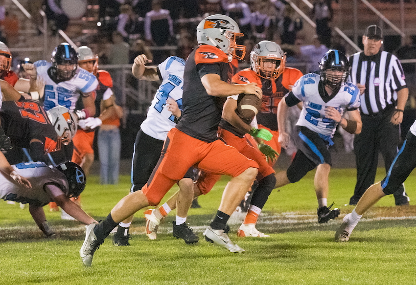 Lansing Catholic defenders close in on a Charlotte ball carrier during the Orioles’ 35-17 win.