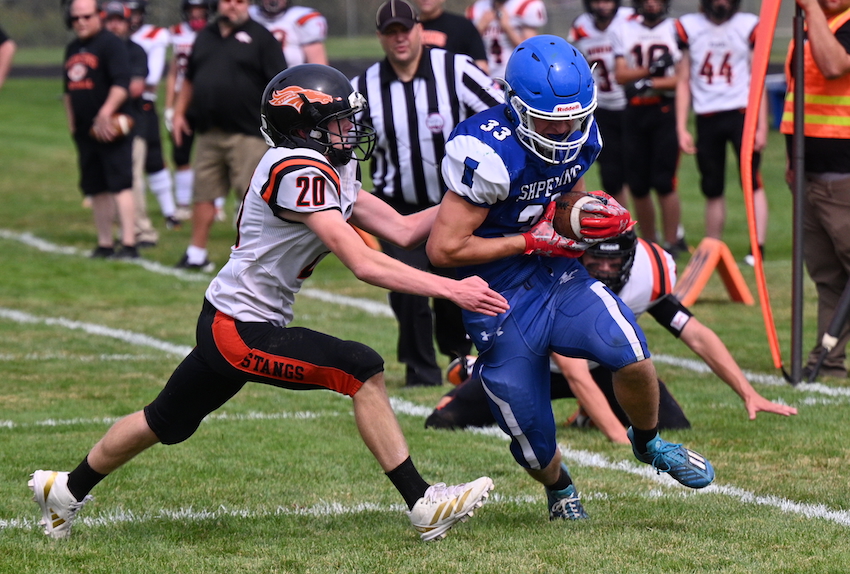 Ishpeming's Josh Wojie is able to break a couple of tackles and get past Munising’s MJ Bell for a touchdown during the Hematites 52-14 victory.