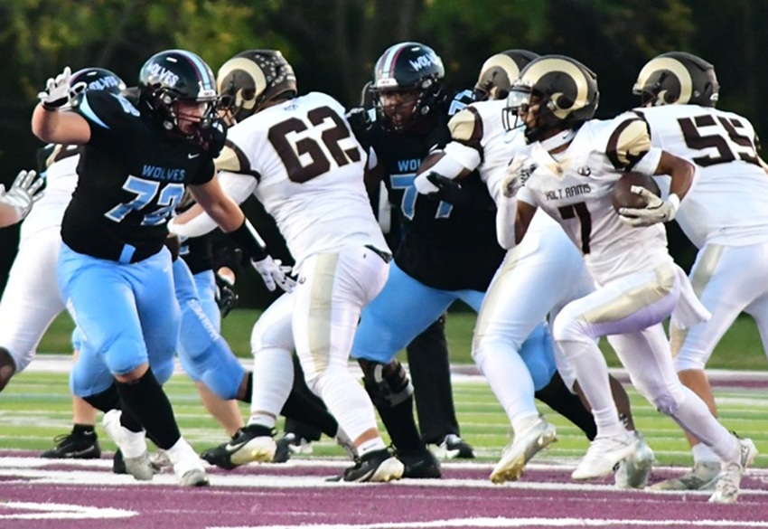A Holt ball carrier works to get outside during the Rams' 42-14 win over Okemos.