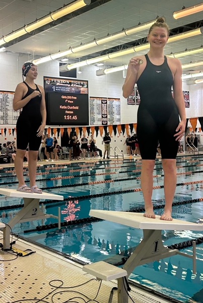 Dunfield holds up her medal after being announced as winner of the 200 freestyle at the Genesee County Invitational.