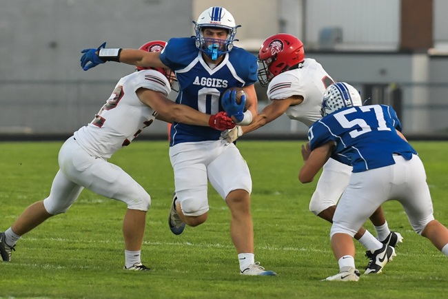 A Beal City ball carrier attempts to break free during his team's 58-0 win over Lake City.