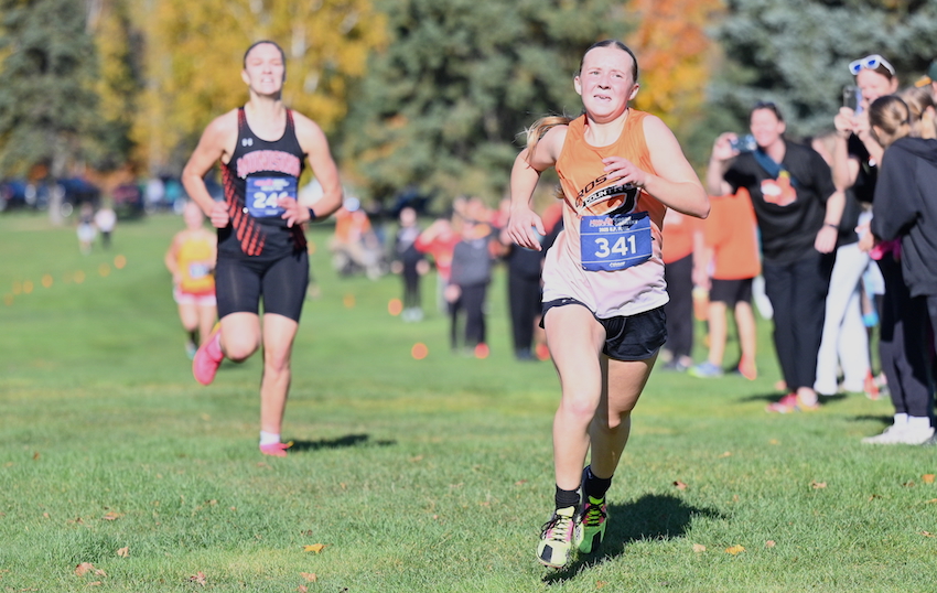 As Rudyard's Melissa Kirschner approaches the finish line, Munising's Addie Bowernman challenges.