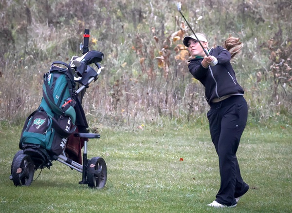 Napoleon's Anna McCubbins follows an approach shot Saturday.