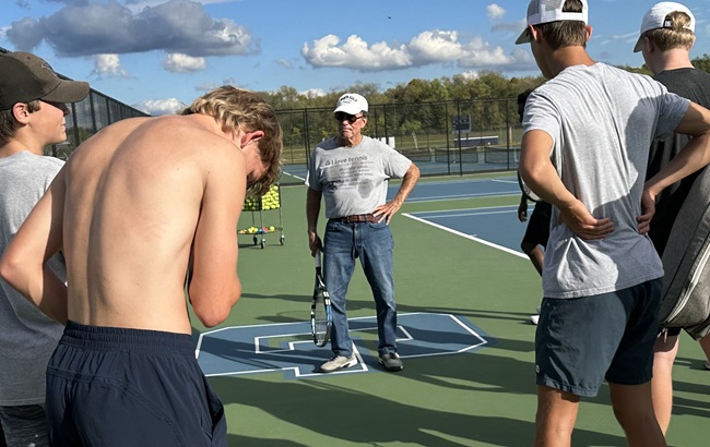 Cornelius talks things over with his team. 