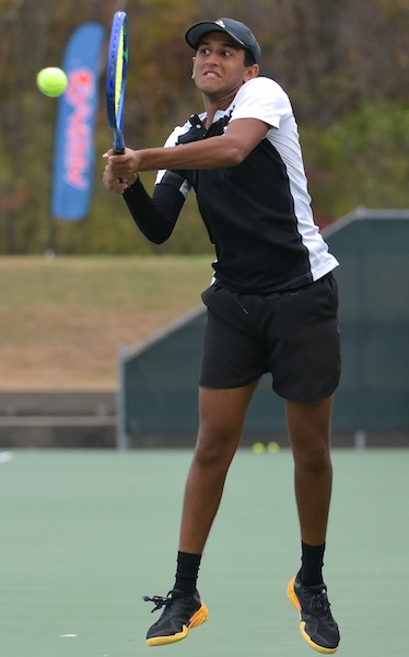 Lansing Christian's Stephen Gollapalli returns a volley at No. 1 singles.