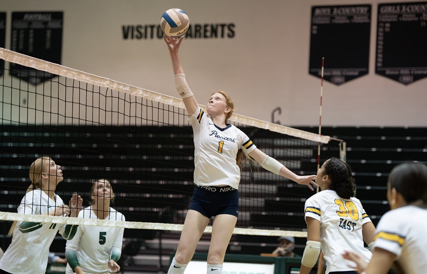 East Grand Rapids' Heidi White (1) elevates to get to the ball against Grand Rapids Forest Hills Central.