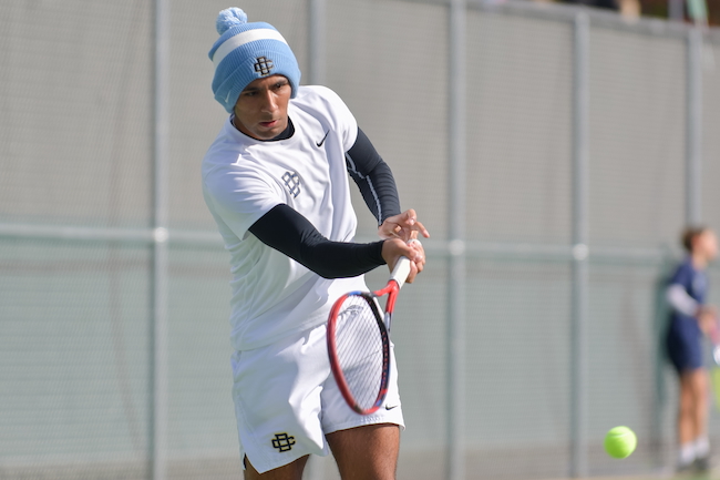 A Country Day tennis player hits a forehand.