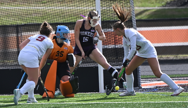Pioneer's Izzy Sutton (15). and Mara Buillon (35) defend their goal with Dexter's Allison St. Amour (9) and Kylie Marcinkowski working to score. 