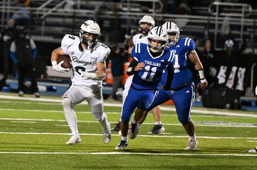 Otsego's Lane Blanchard (8) is chased by Plainwell defenders during the Bulldogs' 39-0 win. 
