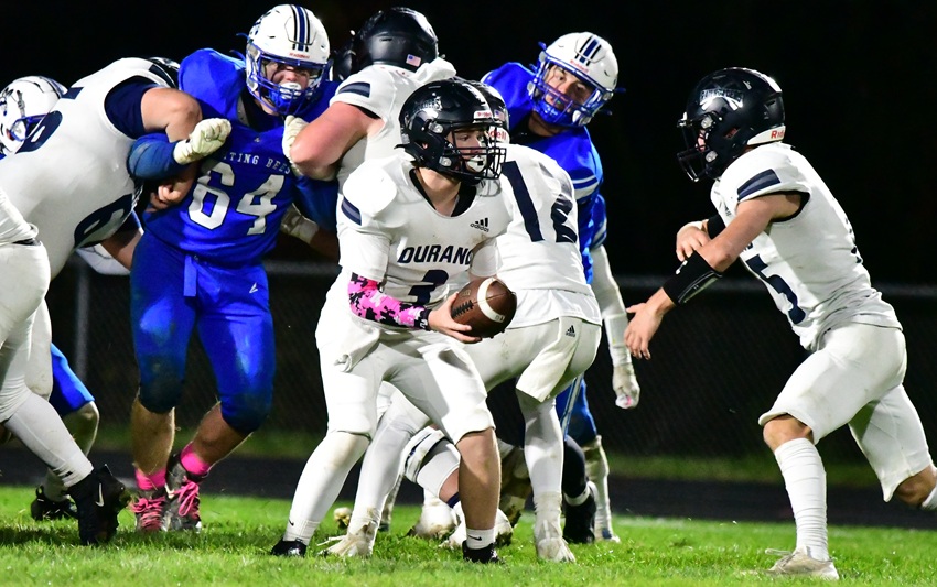  Durand hands off the ball as blockers hold back Bath's defenders during the Railroaders' 50-0 victory. 