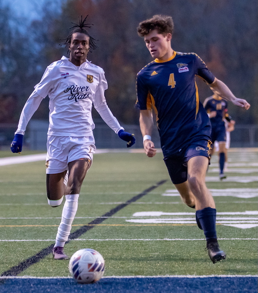 AJ Giebel (4) controls possession for the Mustangs with Huron’s Nasser Diarra in pursuit. 